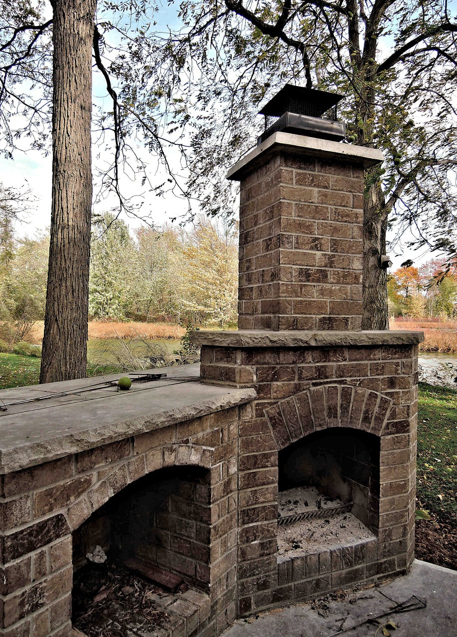 an outdoor fireplace made of stone, brick, and concrete in fort mill
